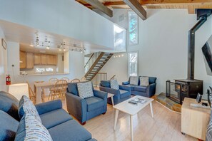 A spacious living area with a staircase, a fireplace, and a dining area. - Charming Condo with Shared Hot Tub, Pool, Resort Amenities - Close to Ski & Beach (Carnelian Bay)