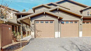 A residential building with a garage, a covered driveway, and a utility box. - Quiet Townhouse in Ideal Truckee Location with Pool, Hot Tub & Sauna (Truckee)