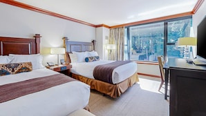 A hotel room with two beds, a desk, a chair, and a large window with a view. - Everline Resort & Spa studio - Ski-in-ski-out, pools, hot tubs, & full spa (Olympic Valley)