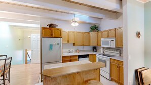 A kitchen with wooden cabinets, a refrigerator, a microwave, an oven, and a sink. - Forest-view condo with wood fireplace & walkable locale - dog-friendly (Incline Village)