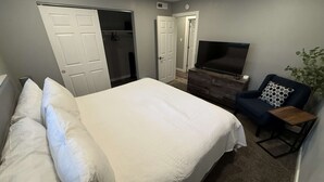 A bedroom with a bed, a TV, a dresser, and a chair. - Forest-view condo with wood fireplace & walkable locale - dog-friendly (Incline Village)