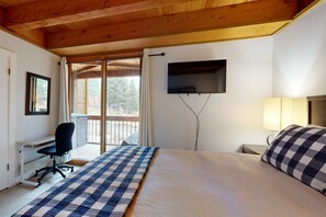 A bedroom with a bed, desk, chair, TV, and window. - Mountain Condo with Fireplace, Balcony, WiFi (NorthStar-Truckee)