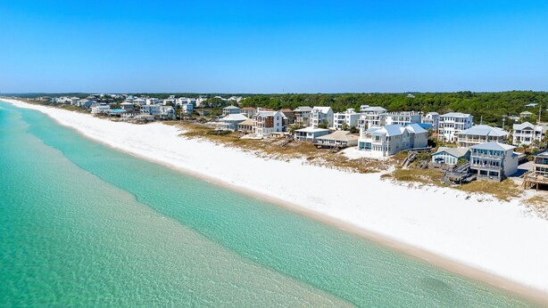 A coastal residential area with beachfront properties, clear turquoise waters, and a clear sky. - Under New Management! Designed for Family Fun w/Golf Cart&Bikes (Santa Rosa Beach)