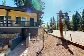 A building with a balcony, a sign for 'The Chalet at Three Beach,' and a street with vehicles. - Mountain-side home base with fireplace, WiFi, full kitchen & patio with firepit (Kings Beach)
