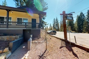 A building with a balcony, a sign reading 'The Chalet,' and a road with vehicles.