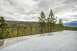 A concrete terrace with a metal railing, overlooking a mountainous landscape with trees. - Lake- & mountain-view lodge with hot tub, rooftop deck & pool table, sleeps 10 (Zephyr Cove)