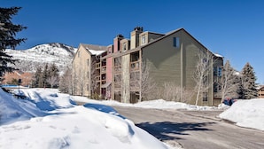 A multi-story building with a snow-covered street in front. - Mountain Condo with  Shared Hot Tub & Pool, High-Speed WiFi, & Private washer & dryer (Park City)