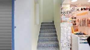 A staircase leading to a shop with various items displayed.