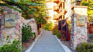 A stone pathway leading to a building with 'CLUB SOLITUDE' and 'EAGLE SPRINGS LODGE EAST' signs. - Ski-in - ski-out Condo with Shared Pool, Hot Tub & More - Awesome Views (Solitude)