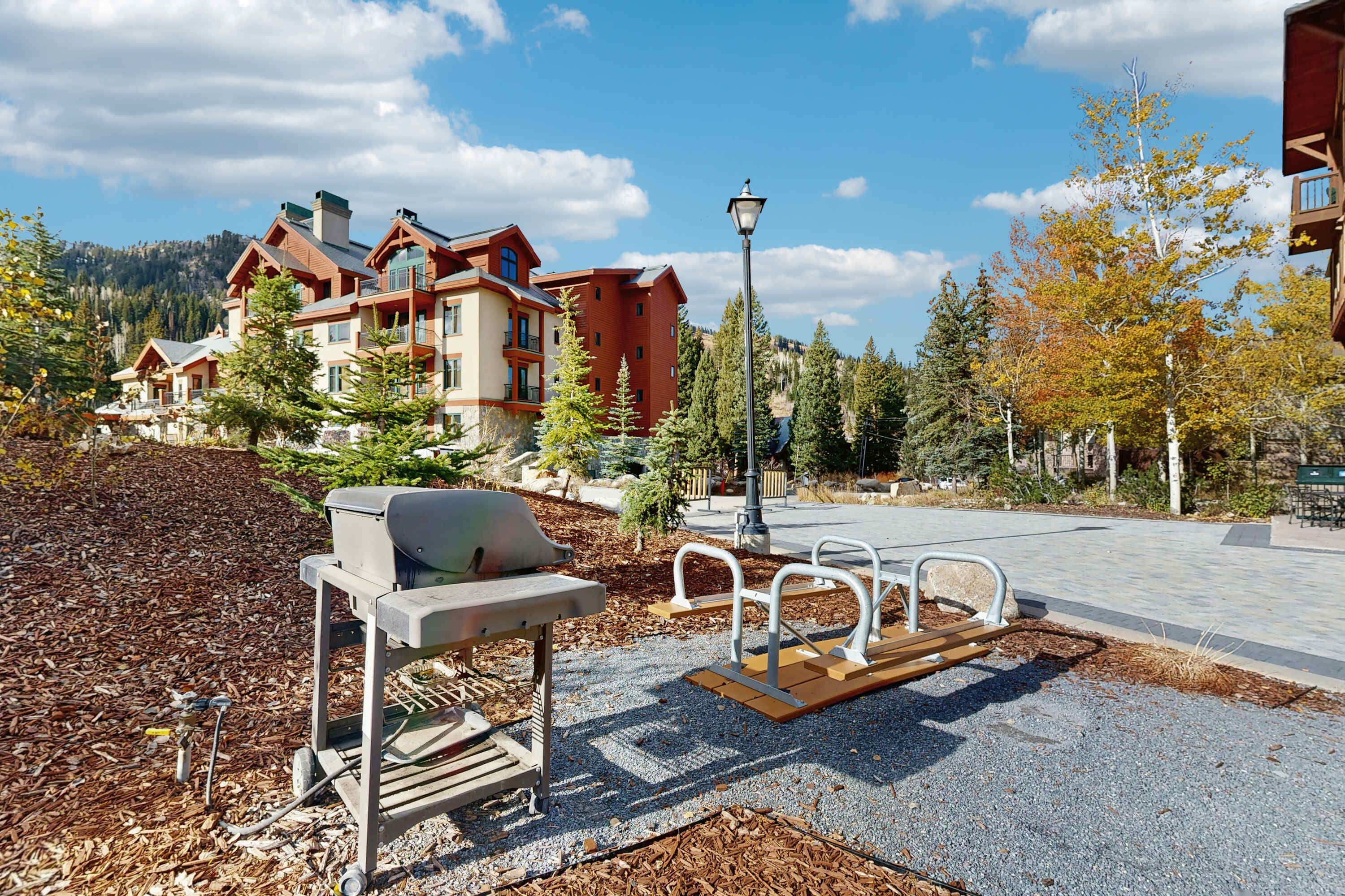 A lodge with a patio area, outdoor seating, and a view of a mountain.