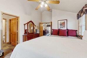 A bedroom with a bed, a dresser, a mirror, a ceiling fan, and a window with blinds. - Mountain view home with hot tub, fireplace & perfect walk-to-lift location (Park City)