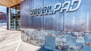 A building with a stone facade and a sign that reads 'HotelPad.' - Walk-to-lift studio with hot tub, sauna, pool, gym, & game room - Dog friendly (Park City)
