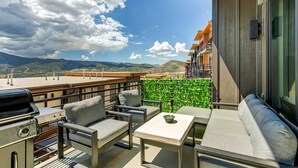 A balcony with outdoor furniture, a grill, and a view of mountains. - Brand-new townhome with views & hot tub  - 12 mins to Park City & Deer Valley (Hideout)