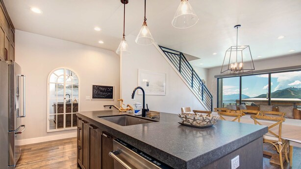 A modern kitchen with a large island, stainless steel appliances, and pendant lighting. - Brand-new townhome with views & hot tub  - 12 mins to Park City & Deer Valley (Hideout)