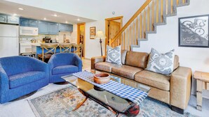 A living room with a sofa, two armchairs, a coffee table, and a staircase. - Two Lofts, Mountain Views, Gas Fireplace, Shared Seasonal Hot Tub & Pools (Park City)