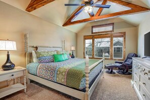 A bedroom with a bed, a nightstand, a dresser, a chair, and a ceiling fan. - Recently updated townhome with  a private hot tub, deck, & wet bar - bus to slopes (Cottonwood Heights)