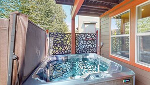 A hot tub with a clear view of the interior, a wooden deck, and a house in the background. - Spacious townhome with pool, private hot tub & clubhouse - Dog Friendly (Kamas)