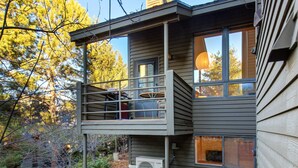 A two-story house with a balcony, large windows, and an air conditioning unit. - Modern mountain escape with wonderful views, pool, hot tub-minutes to skiing (Park City)