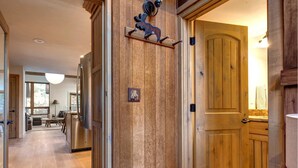 A wooden interior with a dining area, kitchen, and a door with a moose decoration. - Modern mountain escape with wonderful views, pool, hot tub-minutes to skiing (Park City)