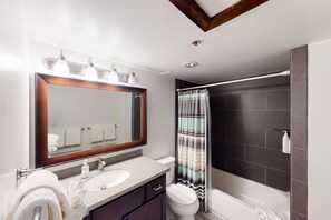 A bathroom with a sink, mirror, toilet, and shower. - Dog-friendly Old Town Empire Condo near resort with  ski storage (Park City)