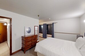 A bedroom with a bed, a dresser, a mirror, and a window with curtains. - Dog-friendly Old Town Empire Condo near resort with  ski storage (Park City)