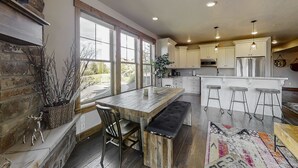 A modern kitchen with a large island, bar stools, and a bench. - Chic 3BR Mountain Condo Minutes to Deer Valley Gondola & Downtown Park City (Heber City)