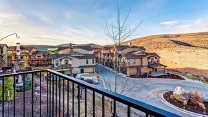 A residential area with houses, a clear sky, and a hilly landscape in the background. - Home with  fireplace, private hot tub, shared pool, game and fitness facilities (Kamas)