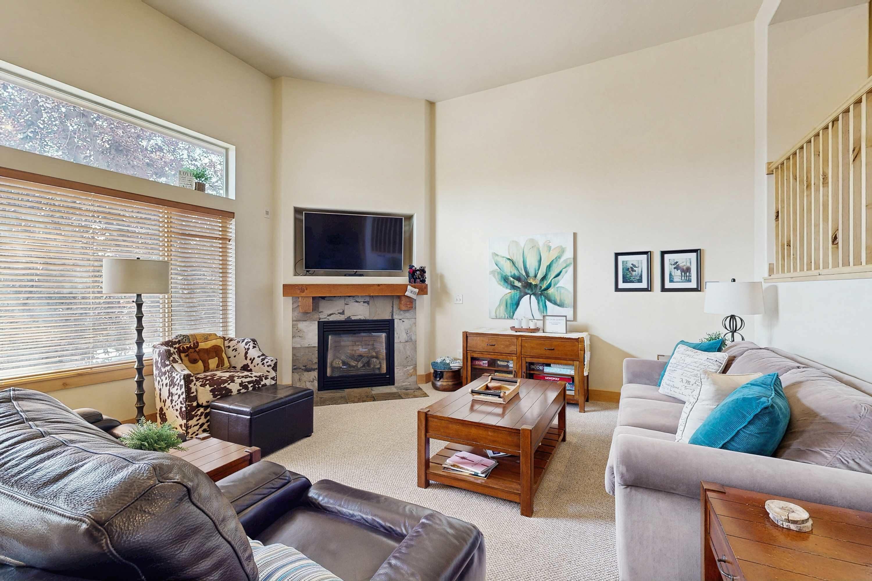 A living room with a fireplace, a television, and a sofa.