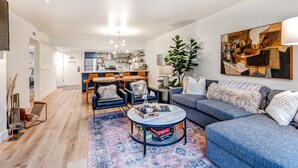 A modern living room with a sofa, coffee table, and chairs. There is a kitchen in the background with a dining area. - Beautifully Updated Luxury Condo -Hot Tub - Walk to Town Lift (Park City)