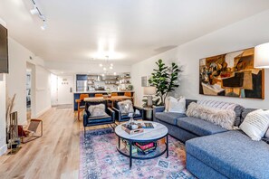 A modern living room with a sofa, coffee table, and chairs. There is a kitchen in the background with a dining area. - Beautifully Updated Luxury Condo -Hot Tub - Walk to Town Lift (Park City)