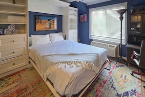 A bedroom with a bed, white dresser, and a colorful rug. - Top-floor, mountain view condo with pool & hot tub - steps to shuttle (Park City)