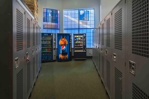 A hallway with lockers, vending machines, and large windows. - Top-floor, mountain view condo with pool & hot tub - steps to shuttle (Park City)