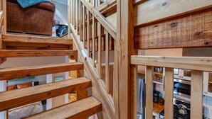 A wooden staircase with a view of a kitchen area below. - Quintessential Historic Old Town-Full Kitchen-Mountain Views (Park City)