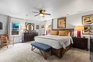 A bedroom with a bed, a bench, a dresser, a mirror, and a ceiling fan. - Stylish condo in prime location just steps from Main Street & Town Lift Plaza (Park City)