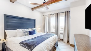 A bedroom with a bed, a ceiling fan, a nightstand, and a window with curtains. - Ski-in-ski-out condo - indoor & outdoor pools, sauna, hot tubs, game room, gym, W&D, AC (Park City)