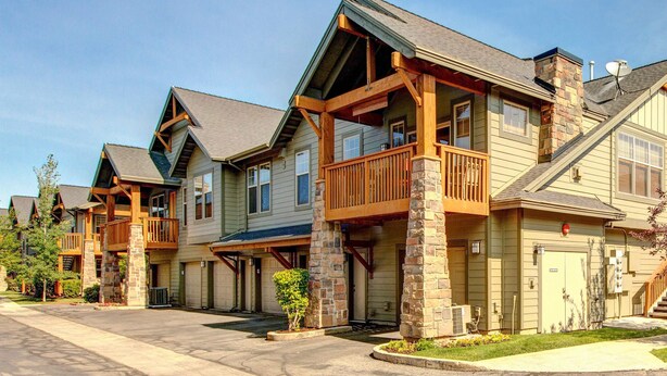 A row of multi-story buildings with balconies, a garage, and a driveway. - Spacious Redstone Home with Fireplace, Patio & Walk to Dining (Park City)