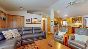 A living room with a sofa, armchairs, a coffee table, and a ceiling fan. - Comfy Home with Private Hot Tub, SHARC Passes & Entertainment (Sunriver)