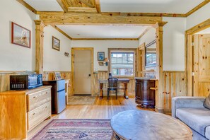 A wooden interior with a kitchen, dining area, and living room.