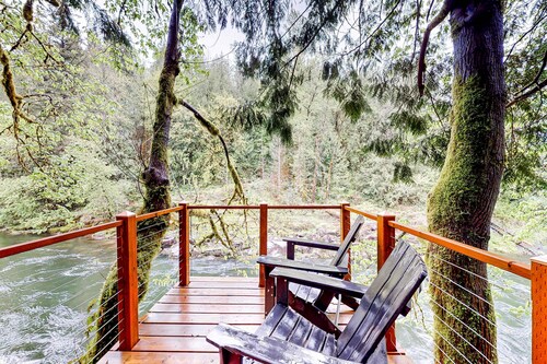 Unwind in nature's embrace at a 1925 cabin with hot tub & river views