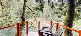 Unwind in nature's embrace at a 1925 cabin with hot tub & river views