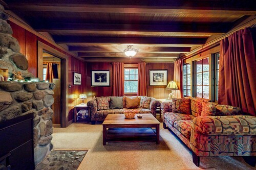 Unwind in nature's embrace at a 1925 cabin with hot tub & river views