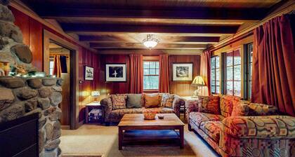 Unwind in nature's embrace at a 1925 cabin with hot tub & river views