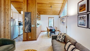 Un intérieur en bois comprenant un coin repas, une cuisine et un espace de vie.