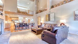 A spacious living area with a high ceiling, a dining area, and a kitchen. - Beautiful penthouse condo w/shared pool & hot tub - amazing views & free WiFi (Government Camp)