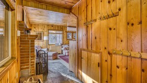 A wooden interior with a staircase, a coat rack, and a cozy seating area. - Cozy pine interior home in the heart of Government Camp (Government Camp)