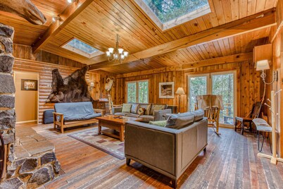 Rustic lodge with private hot tub, fireplace & riverfront views - dog-friendly