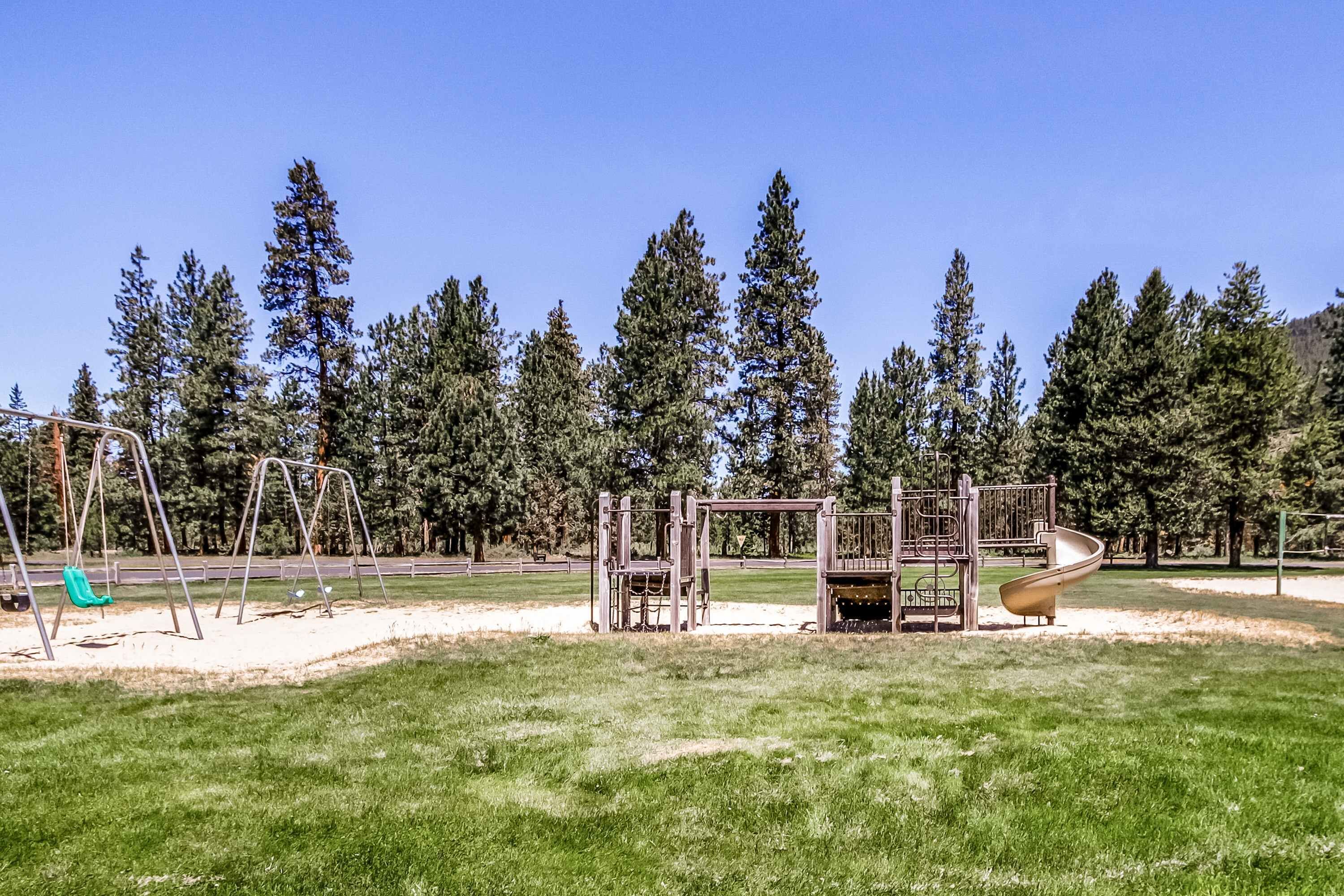 A playground with swings, a slide, and climbing structures.