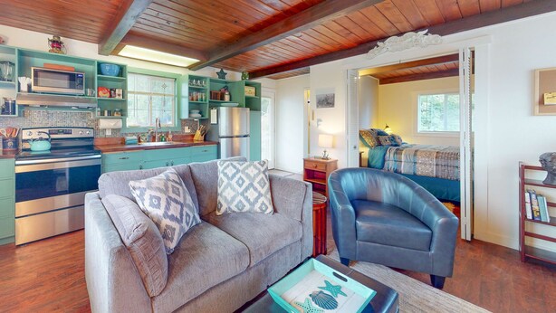 A cozy living room with a sofa, armchair, and a coffee table.