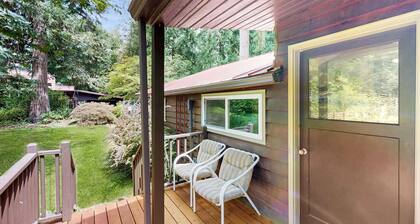Tranquil landscape with riverside firepit, gas grill, gas fireplace, and deck