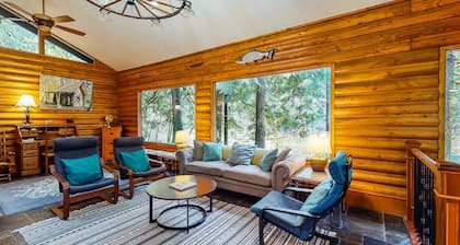 Spacious riverfront lodge with beach access, private hot tub & forest views